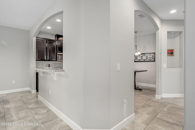 hall featuring light tile patterned flooring