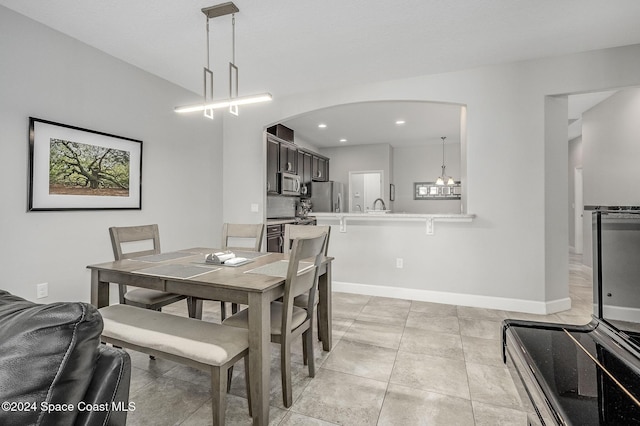 dining room with sink and light tile patterned flooring