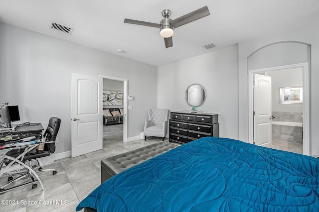 tiled bedroom with ensuite bath and ceiling fan