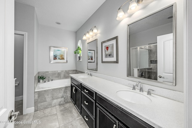 bathroom featuring tile patterned flooring, vanity, and independent shower and bath