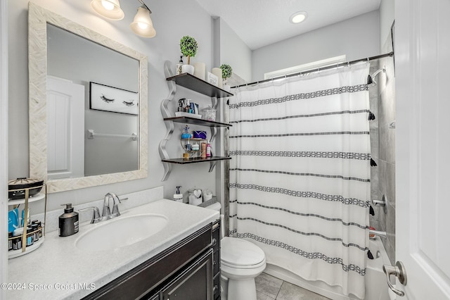 bathroom featuring tile patterned floors, vanity, and toilet