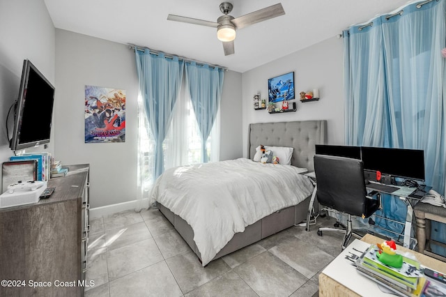 tiled bedroom featuring ceiling fan