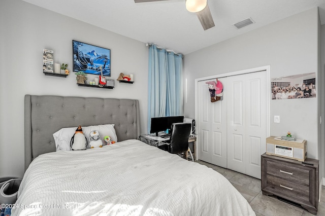 tiled bedroom featuring a closet and ceiling fan