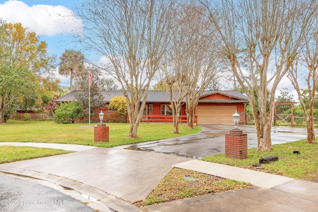 view of front of home with a garage and a front lawn