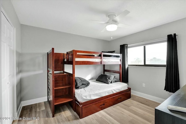 bedroom featuring ceiling fan, a closet, and light hardwood / wood-style flooring