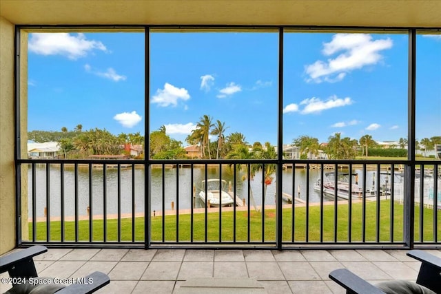 unfurnished sunroom with a water view