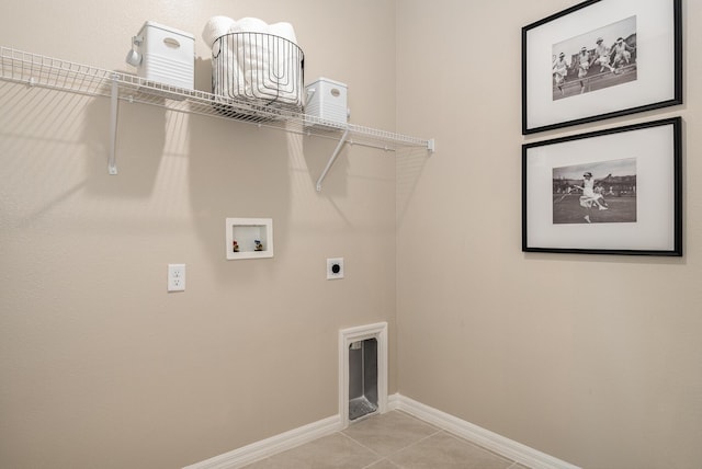 washroom with hookup for an electric dryer, light tile patterned floors, and hookup for a washing machine