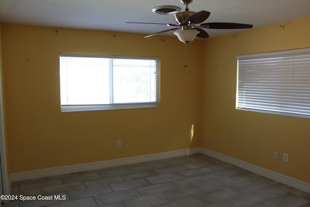 unfurnished room with ceiling fan