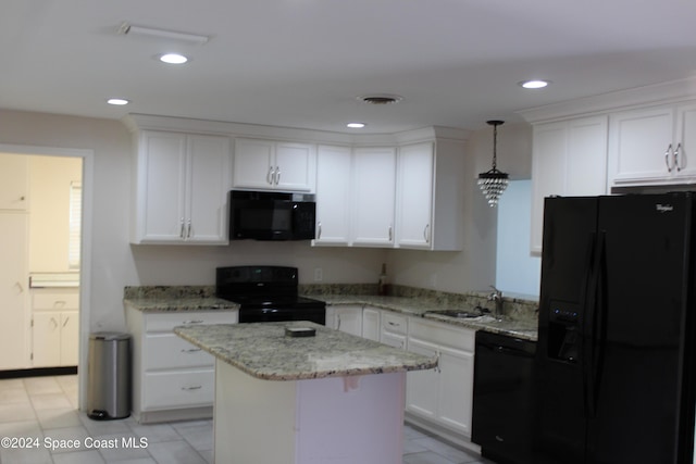 kitchen with sink, hanging light fixtures, a kitchen island, white cabinets, and black appliances