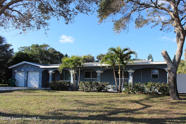 single story home featuring a front yard and a garage