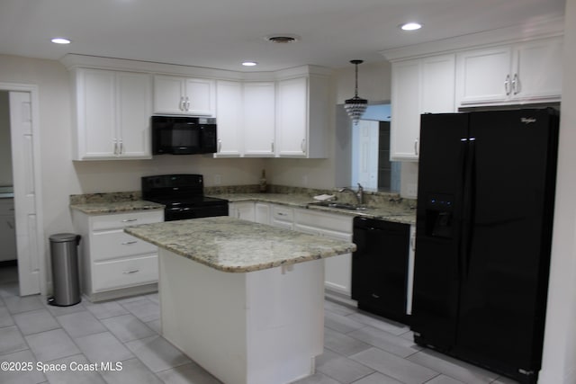 kitchen with pendant lighting, sink, white cabinetry, and black appliances