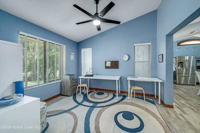 home office with light wood-type flooring, vaulted ceiling, and ceiling fan