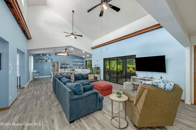 living room with light hardwood / wood-style floors and high vaulted ceiling