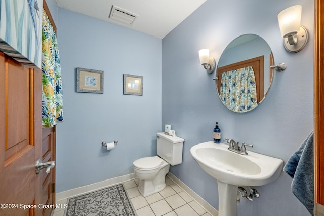 bathroom with tile patterned floors and toilet