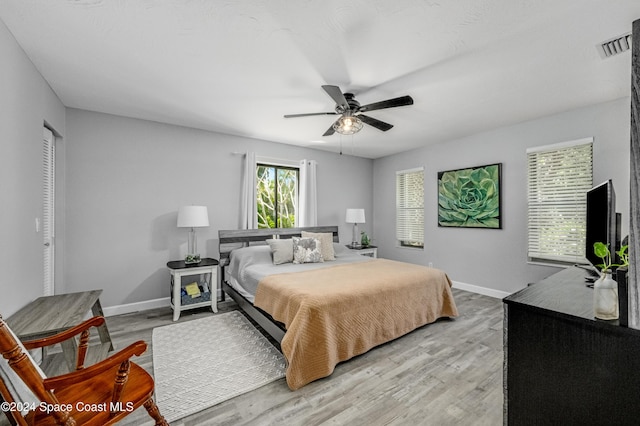 bedroom with ceiling fan and light wood-type flooring