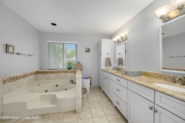 bathroom featuring tile patterned floors, a washtub, and vanity