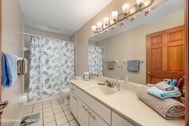 bathroom featuring toilet, vanity, tile patterned floors, and curtained shower