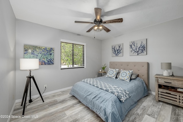 bedroom featuring light hardwood / wood-style floors and ceiling fan