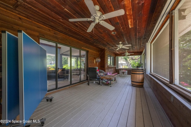 unfurnished sunroom with ceiling fan and wooden ceiling