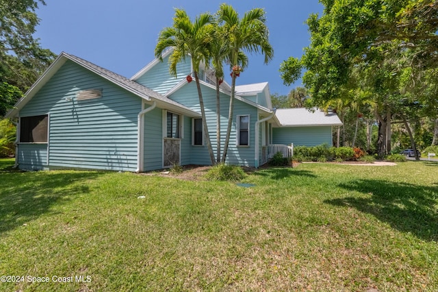 rear view of property with a lawn