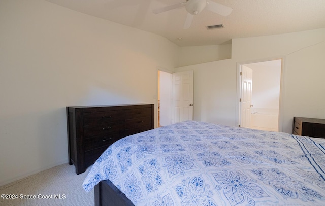 carpeted bedroom featuring ceiling fan, ensuite bathroom, and lofted ceiling