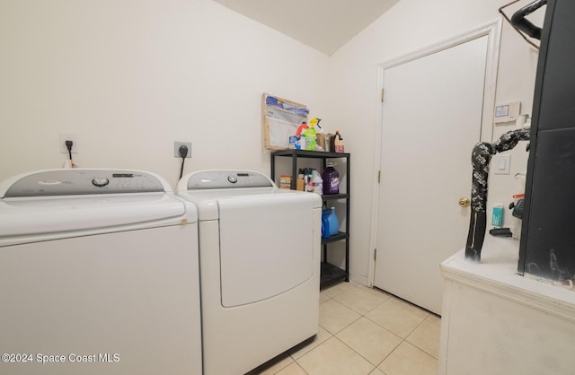 clothes washing area with independent washer and dryer and light tile patterned floors