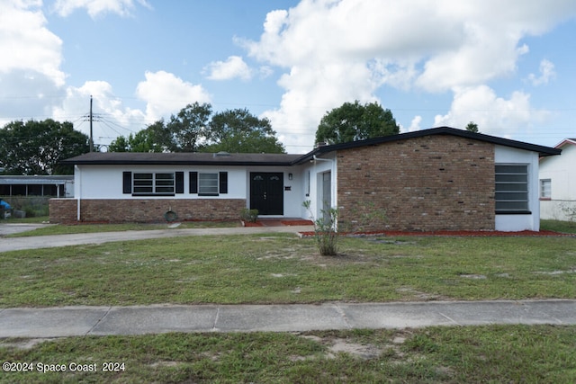 ranch-style home featuring a front yard