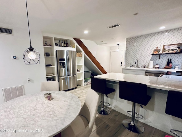 dining room with sink and light wood-type flooring