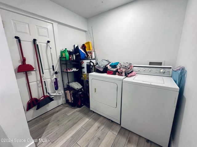 washroom featuring separate washer and dryer and light hardwood / wood-style floors