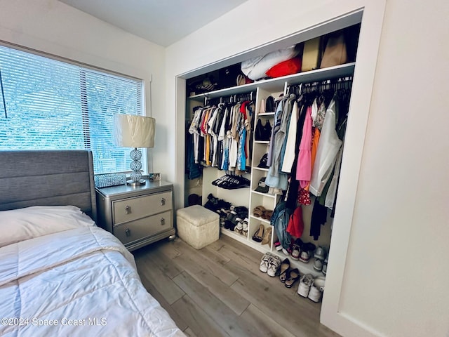 bedroom with hardwood / wood-style flooring and a closet