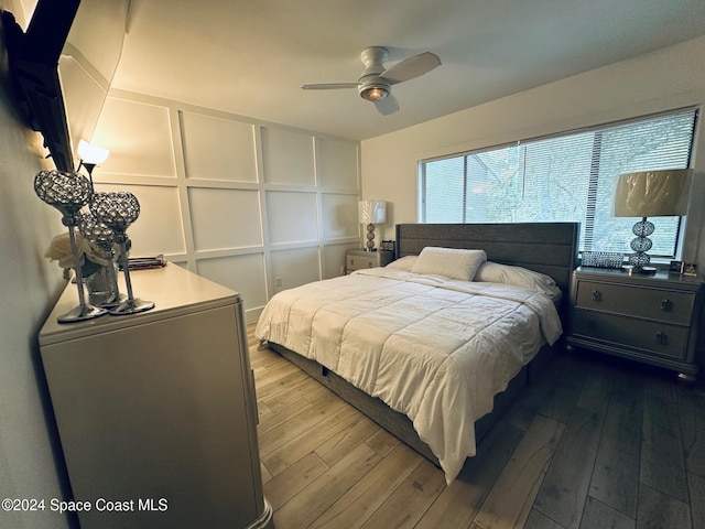 bedroom with ceiling fan and hardwood / wood-style flooring