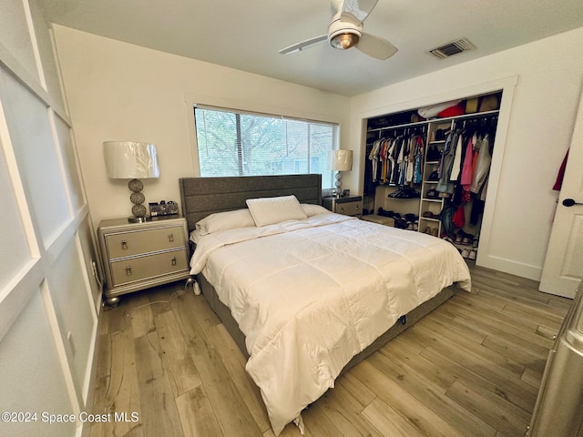 bedroom featuring light hardwood / wood-style floors, a closet, and ceiling fan