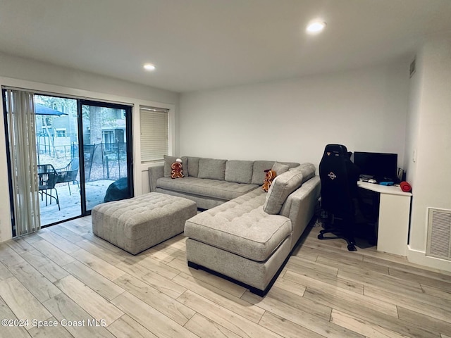 living room featuring built in desk and light hardwood / wood-style floors