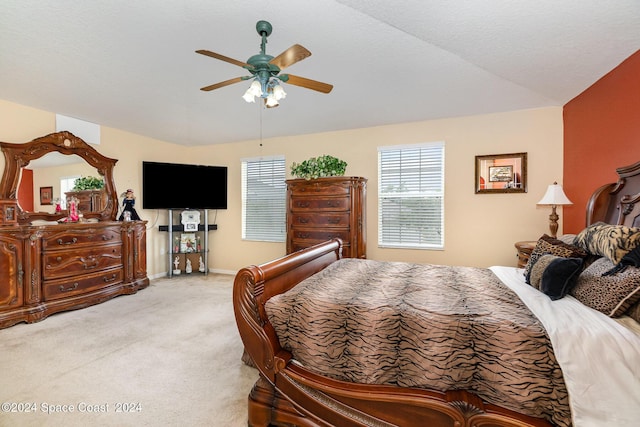 carpeted bedroom featuring ceiling fan and lofted ceiling