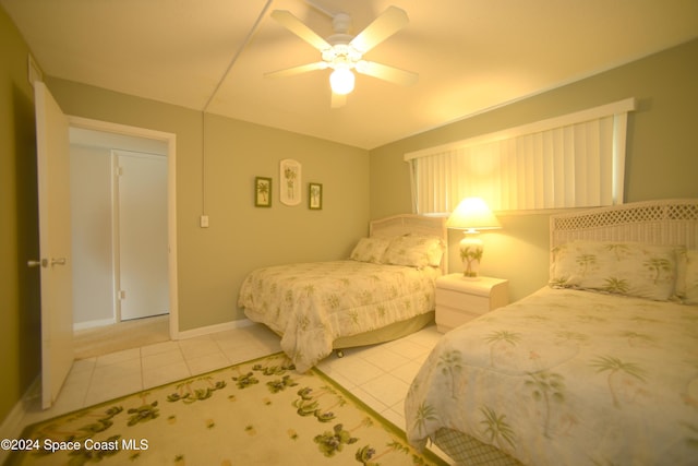 tiled bedroom featuring ceiling fan