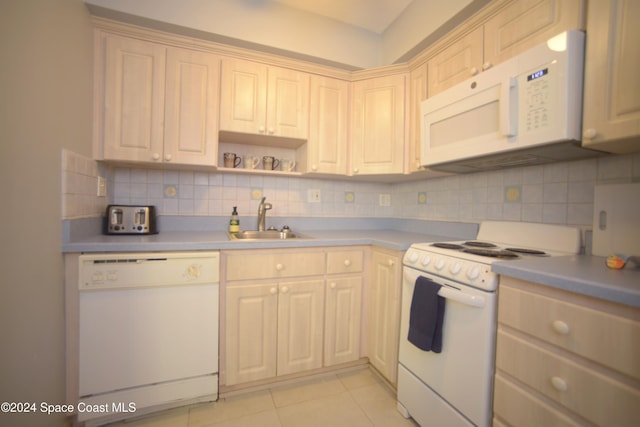 kitchen featuring sink, white appliances, backsplash, and light tile patterned flooring