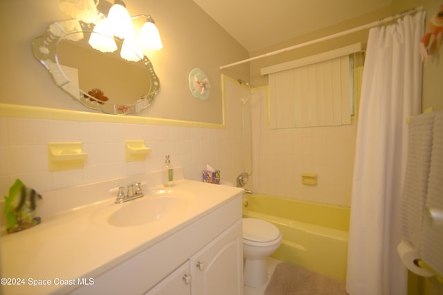 full bathroom with shower / tub combo, vanity, tile walls, and toilet