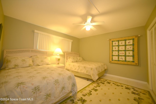 tiled bedroom with ceiling fan