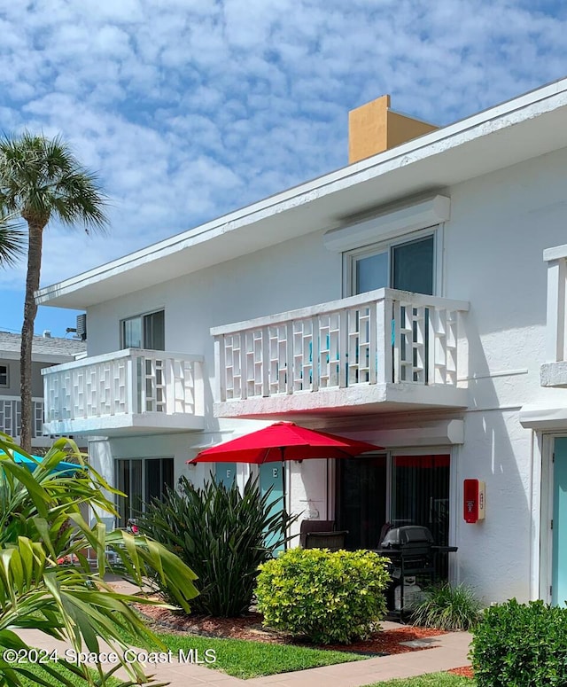 back of house featuring a balcony