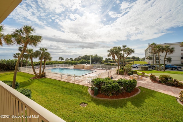 view of pool featuring a lawn and a patio area