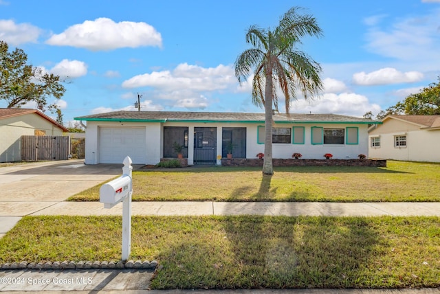 ranch-style home featuring a garage and a front lawn