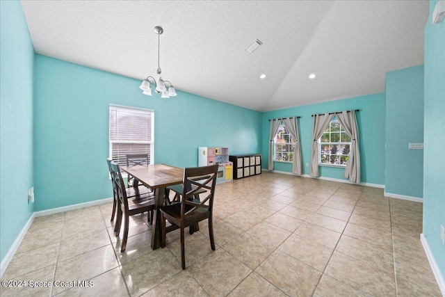 dining area featuring a chandelier, a textured ceiling, and vaulted ceiling