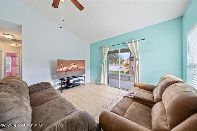 tiled living room featuring ceiling fan, lofted ceiling, and a textured ceiling