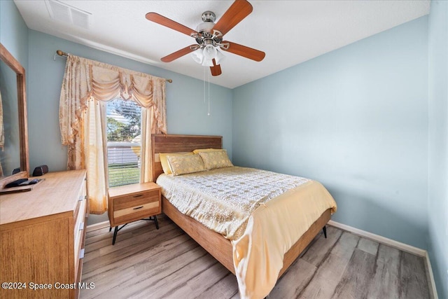 bedroom featuring ceiling fan and light hardwood / wood-style flooring