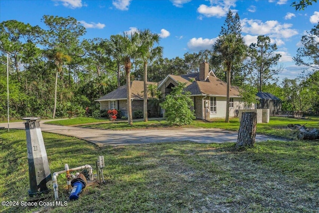 ranch-style house with a lanai and a front lawn