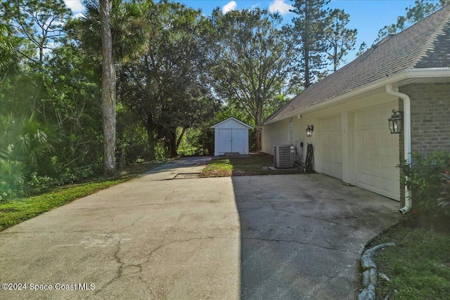 view of patio featuring cooling unit and a shed