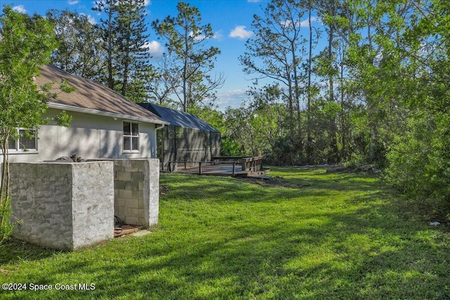 view of yard featuring glass enclosure