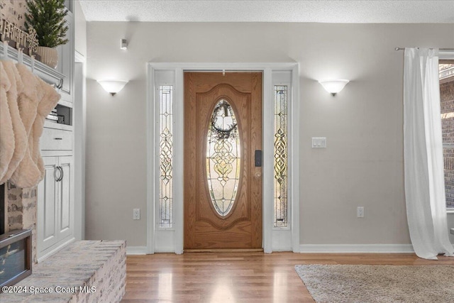 foyer featuring a textured ceiling and hardwood / wood-style flooring