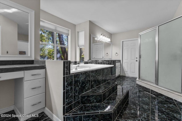 bathroom with vanity and independent shower and bath