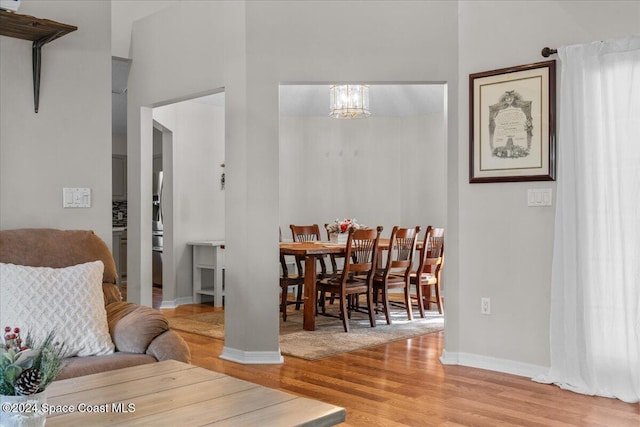 dining room featuring light hardwood / wood-style floors and a notable chandelier